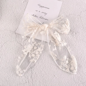 Elegant white lace bow hair clip with floral embroidery and long chiffon ribbons