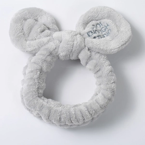 Detail of light gray plush headband with bow and NOT ENOUGH blue letter embroidery