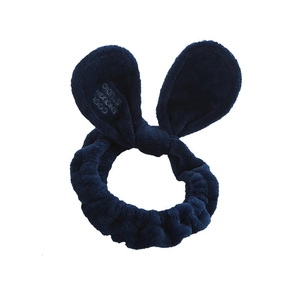 Detail of navy blue plush bunny ear headband showing soft microfiber texture and embroidery