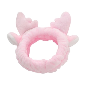 Detailed view of pink plush headband with soft fabric and 3D cartoon antlers