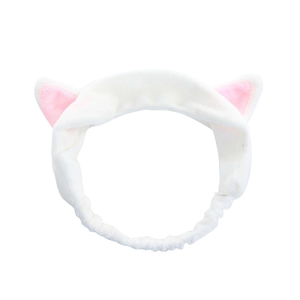 Close-up of soft white plush cat ear headband with pink inner lining and elastic band