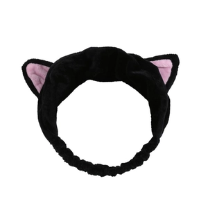 Detail of plush black cat ear headband with soft pink inner lining and elastic band