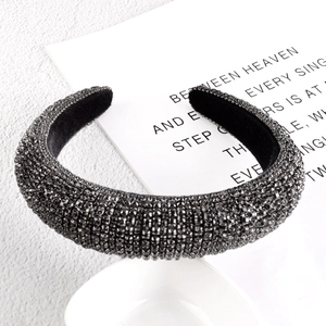 Detailed macro view of padded sponge headband with dense gunmetal grey rhinestones