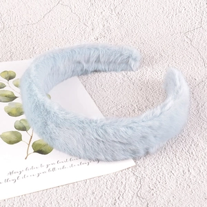 Close-up of soft light blue plush headband texture on decorative background