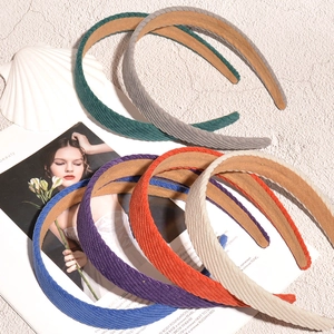 Corduroy striped wide headband set in multiple candy colors on vintage magazines