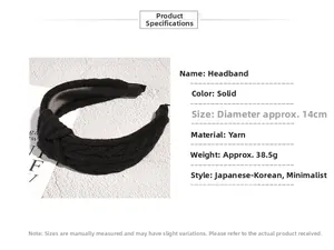 Detail shot of black knitted yarn headband with twist knot and 14cm diameter sizing info