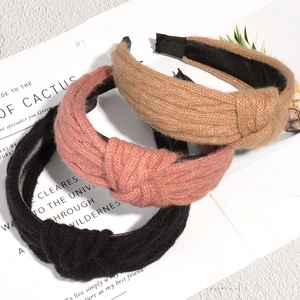 Three-piece set of knitted twist headbands in black, dusty rose, and khaki colors