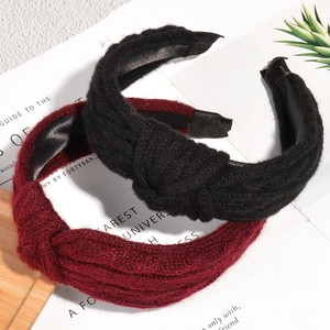 Chic knitted twist headband in black and wine red colors with stylish top knot design