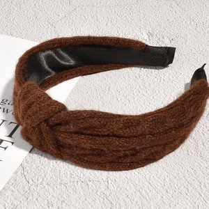 Detail of brown knitted headband showing twisted knot texture and smooth satin lining