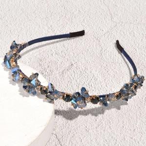 Detailed view of the dark blue fabric headband featuring hand-set sparkling crystals