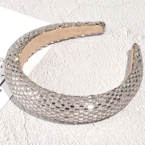 Detailed macro view of sparkling rhinestone padded headband with plush velvet inner lining