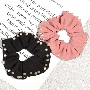 Elegant set of black and pink scrunchies featuring pearl edge trim and pleated texture