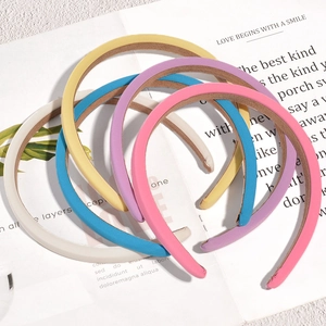 Set of 5 pastel candy colored fabric sponge headbands displayed on stylish magazine