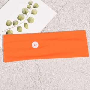 Detail of orange knitted sports headband with functional white side button for masks