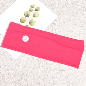 Detail of rose red wide elastic sports headband with functional white side button