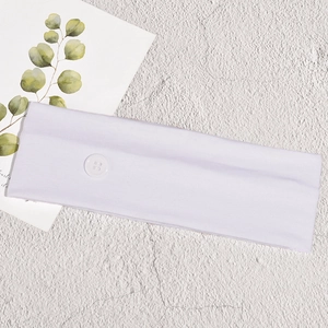 Close-up of white elastic sports headband with buttons for mask ear relief on white background