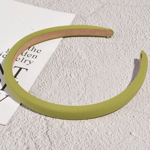 Detail view of the fine knit texture and non-slip lining on this light green sponge headband
