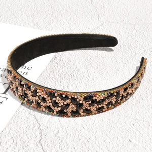 Detailed close-up of baroque leaf headband with rhinestones and rose gold beads