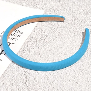 Close-up of sky blue padded headband featuring twill fabric texture and anti-slip lining