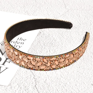 Macro detail of luxury champagne rhinestone leaf headband with sparkling beads and black velvet
