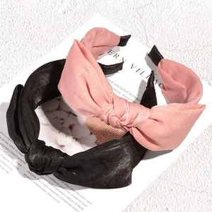 Pink and black knotted fabric headbands in elegant satin style for women