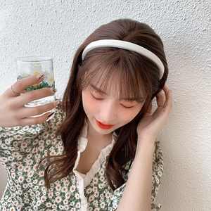 Minimalist white sponge headband shown on a model wearing a green floral daisy dress