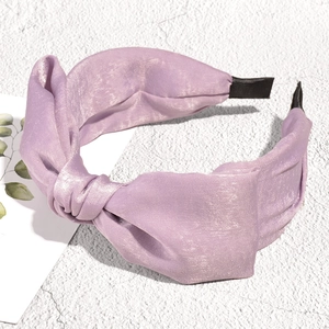Detail of lavender knot headband with silk-like texture and padded wide band style
