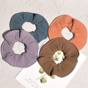 Four-piece set of pleated candy-colored striped scrunchies in blue, purple, orange, and brown
