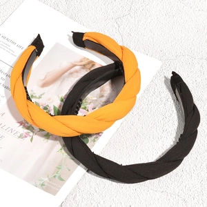 Braided fabric headbands in orange and black with non-slip teeth for secure styling