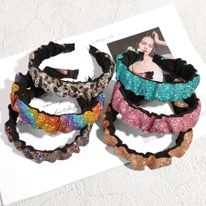 Macro detail of rhinestone pleated headbands in leopard, pink, and gold with sparkling crystals