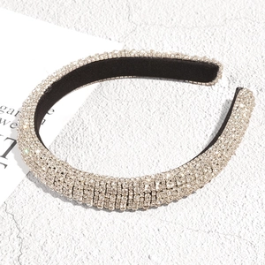 Detail of a padded headband with silver rhinestones and a black velvet inner lining