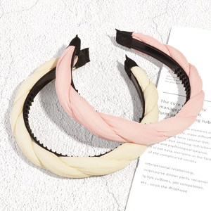 Braided fabric headbands set with non-slip teeth in soft pink and cream yellow colors