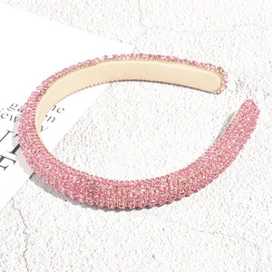 Close-up of a pink rhinestone padded headband with sparkling crystals and luxury design