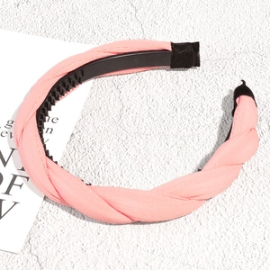 Detail of pink braided headband showing chiffon fabric texture and inner non-slip teeth