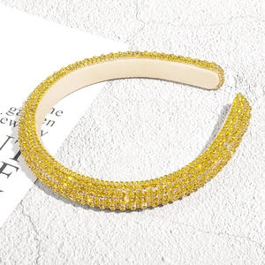 Detail of yellow rhinestone padded headband featuring sparkling faceted crystals