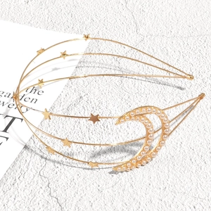 Golden multi-layer headband featuring moon stars and pearl accents on a stone background