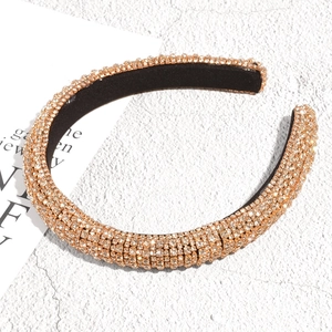 Close-up of sparkling crystal rhinestones and soft black fabric lining on the headband