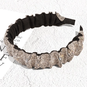 Detailed view of the pleated velvet headband with sparkling silver rhinestones for women
