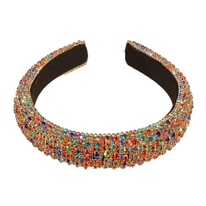 Baroque style padded headband with colorful rhinestones on a white background