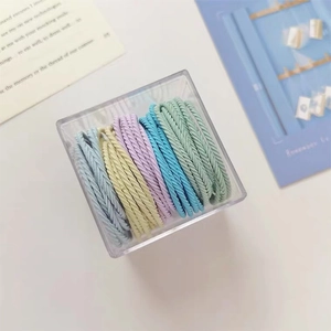 Detailed view of colorful elastic hair ties set in a transparent acrylic storage box