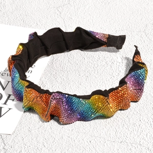 Close-up of rainbow gradient rhinestones on black pleated headband for women