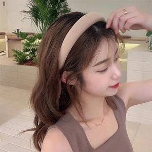 Minimalist beige padded sponge headband for women with a soft textured fabric finish