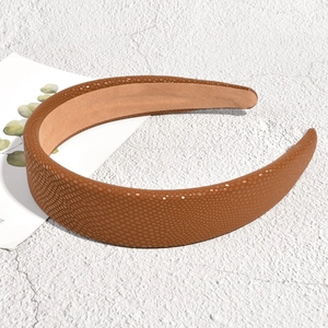 Detail of brown textured headband with granular faux leather finish and soft non-slip lining