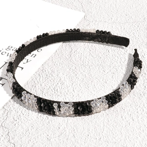Detailed view of black and white crystal headband with hand-wrapped wire and anti-slip tips