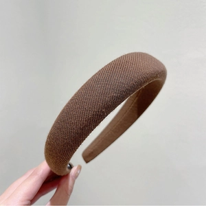 Close-up of brown twill sponge headband featuring thick padded fabric and non-slip inner grip
