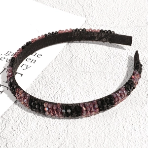 Detail of handcrafted headband featuring black and deep purple faceted crystal beads