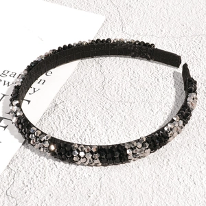 Macro detail of a handcrafted crystal headband with sparkling black and silver beads