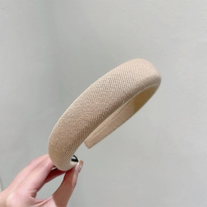 Detail of light khaki knitted sponge headband showing soft fabric texture and thickness