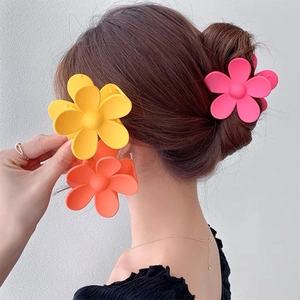 Elegant floral matte hair claw clips in vibrant candy colors worn on hair by model
