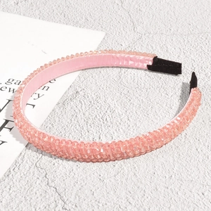 Detail shot of the pink crystal beads and inner fabric lining of the nonslip headband